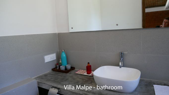 Shows part view of the bathroom with toileteries on tray